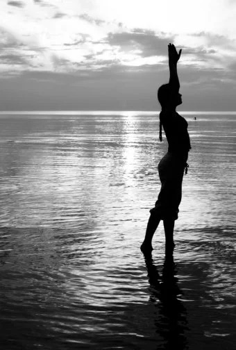 A single graceful Pilates pose at sunrise